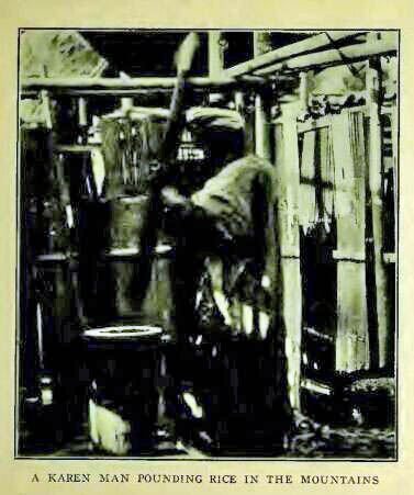 A KAREN MAN POUNDING RICE IN THE MOUNTAINS